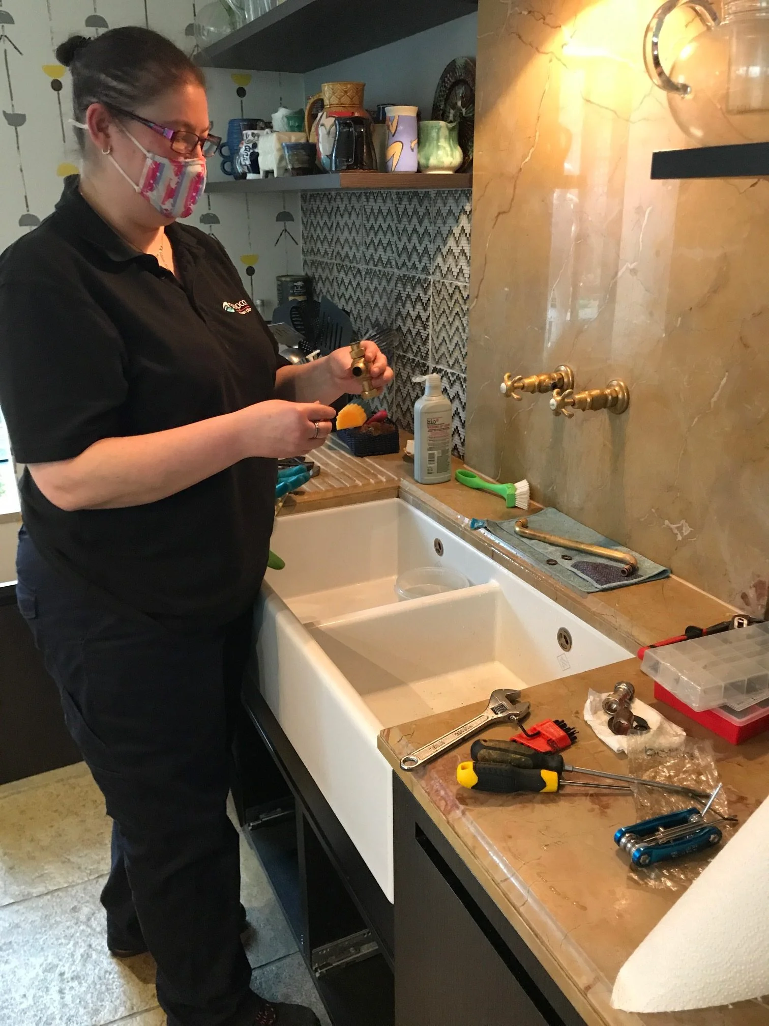 Stopcocks woman plumber working in a customer kitchen